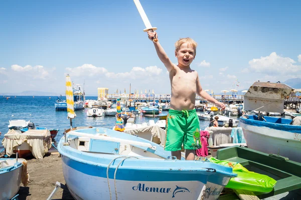Boy playing in boat — Stock Photo, Image