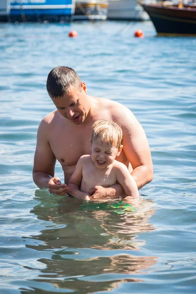 Download Maldives or Miami beach activity joy. Father and son swim ...