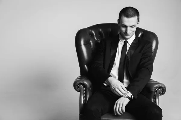 Businessman sitting on leather chair — Stock Photo, Image