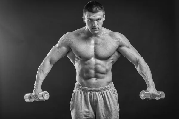 Strong man with dumbbell — Stock Photo, Image