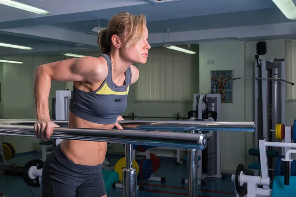 Woman doing exercises in gym.