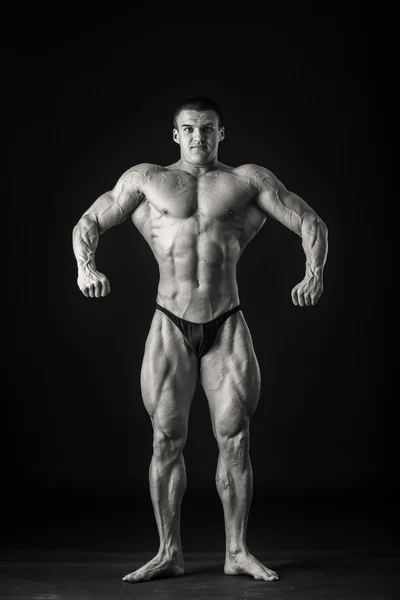 Bodybuilder shows his muscles — Stock Photo, Image