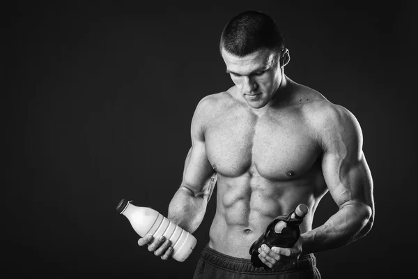 Man holding a beer and milk — Stock Photo, Image