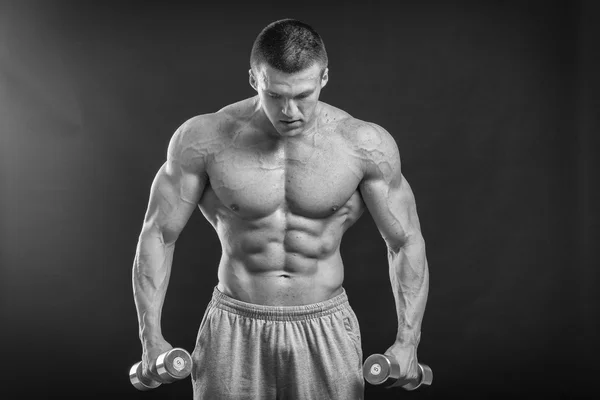 Sportsman holding a dumbbells. — Stock Photo, Image