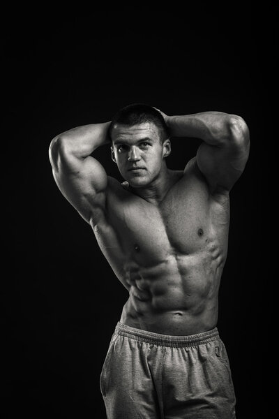Bodybuilder shows his muscles