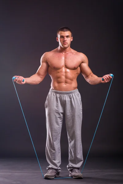 Strong  man with a skipping-rope — Stock Photo, Image