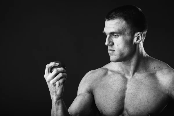 Muscular man holding apple — Stock Photo, Image