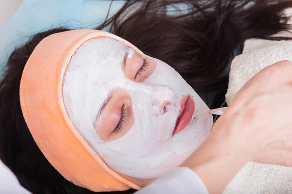 woman having cosmetic facial treatments