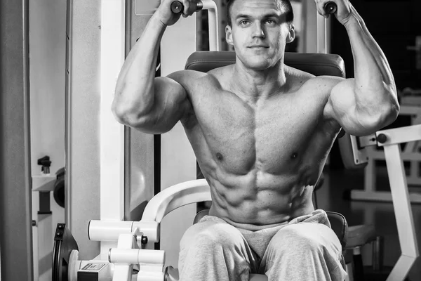 Bodybuilder trainiert die Muskeln der Arme. — Stockfoto
