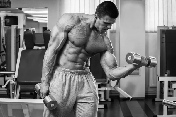 Bodybuilder trainiert die Muskeln der Arme. — Stockfoto