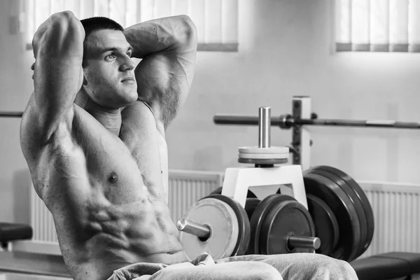 在健身房里抽腹部肌肉的健美运动员 — 图库照片