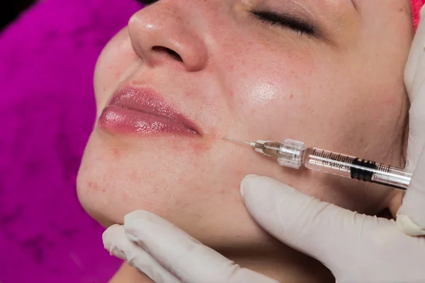 Woman having cosmetic facial treatments — Stock Photo, Image