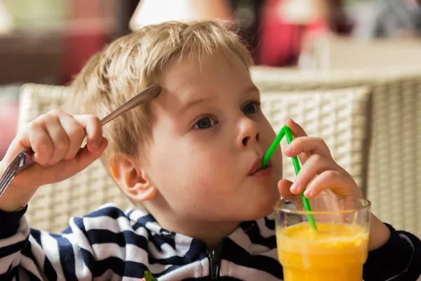 Un chico bebe jugo. —  Fotos de Stock