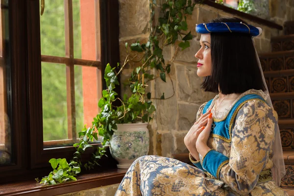 Woman in medieval dress in antique interior — Stock Photo, Image