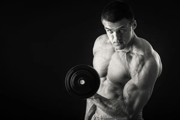 Athletic man exercising with dumbbells — Stock Photo, Image