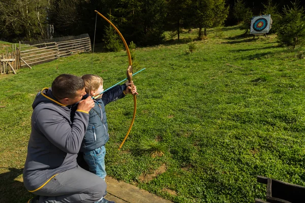 Father and son engaged in archery — Stock Photo, Image