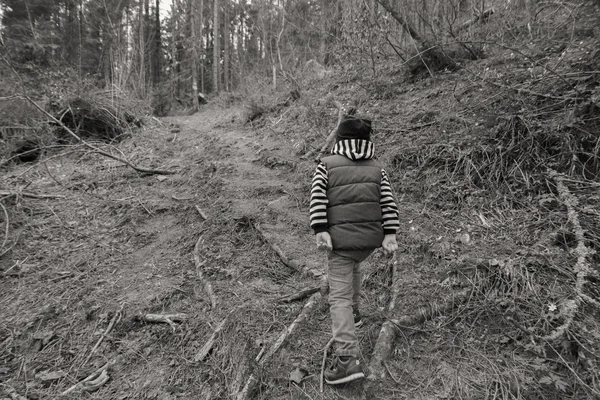 Little boy is resting in the forest