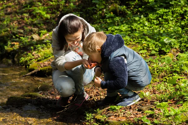 Mother and son in the forest by the river — Stock Photo, Image