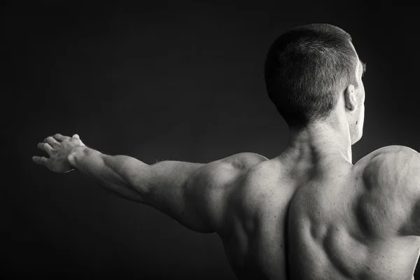 Achterkant van man toont spieren — Stockfoto