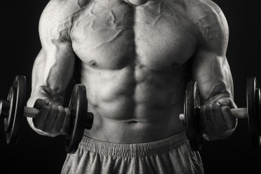 Dambıllarla egzersiz yapan adam.