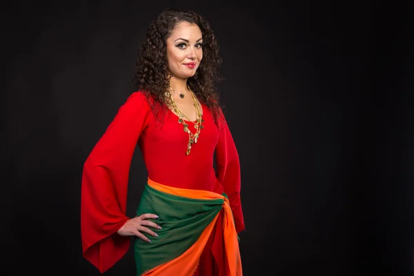 Gorgeous woman in red on a black background — Stock Photo, Image