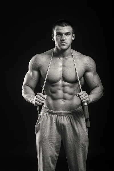 Bodybuilder on a dark background — Stock Photo, Image