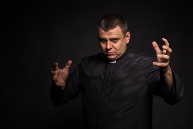 Aktör rahip rol oynamaktadır