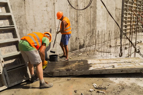 builders pouring the concrete foundation
