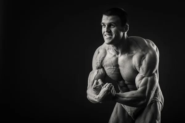 Man shows muscles — Stock Photo, Image