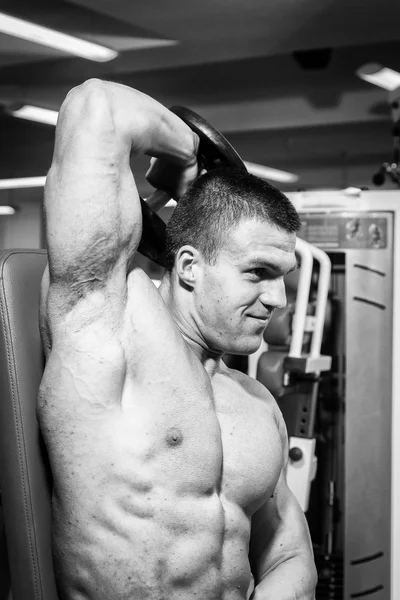 Muscular man working out with dumbbells — Stock Photo, Image