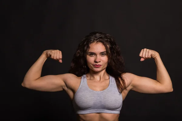 The beautiful sports girl on a dark background — Stock Photo, Image