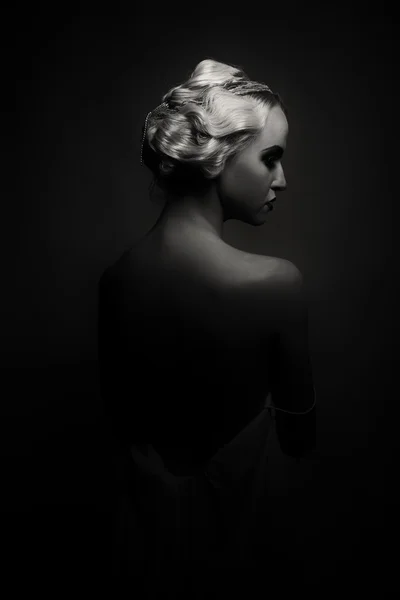 Beautiful blonde in vintage dress on a dark background — Stock Photo, Image