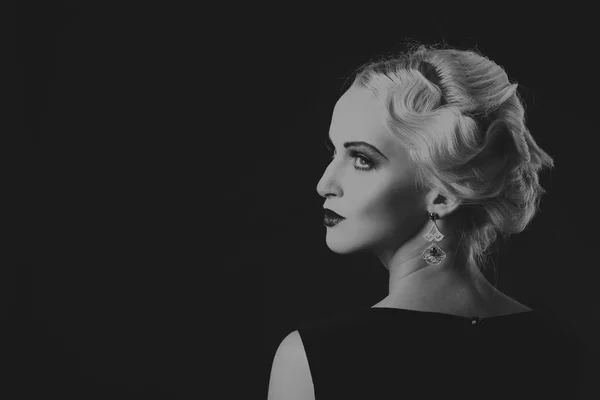 Beautiful blonde in vintage dress on a dark background — Stock Photo, Image