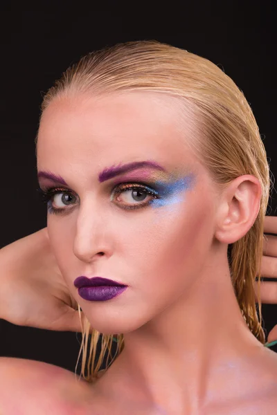 Beautiful model with art makeup on a dark background — Stock Photo, Image