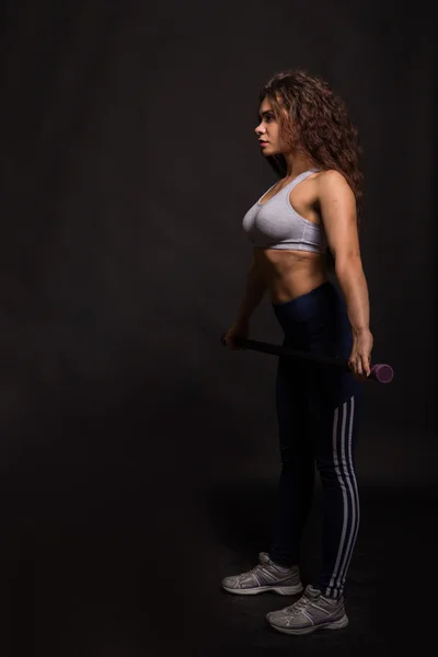 The beautiful sports girl on a dark background — Stock Photo, Image