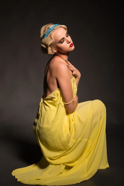 Beautiful blonde in vintage dress on a dark background — Stock Photo, Image