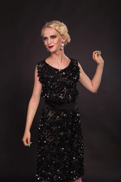 Beautiful blonde in vintage dress on a dark background — Stock Photo, Image