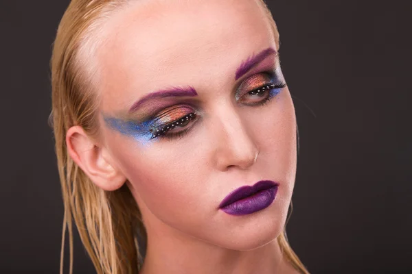 Beautiful model with art makeup on a dark background — Stock Photo, Image