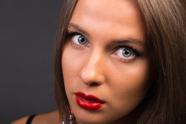 Beautiful brunette in a dark dress — Stock Photo, Image