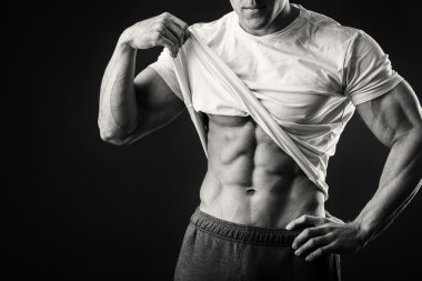 Karanlık bir arka plan üzerinde bir spor ceketli kaslı adamı