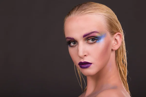 Beautiful model with art makeup on a dark background — Stock Photo, Image