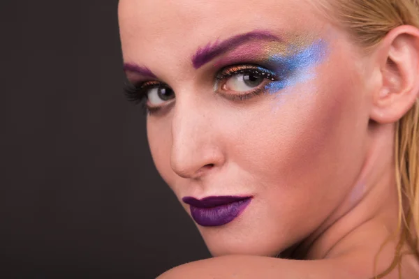 Beautiful model with art makeup on a dark background — Stock Photo, Image
