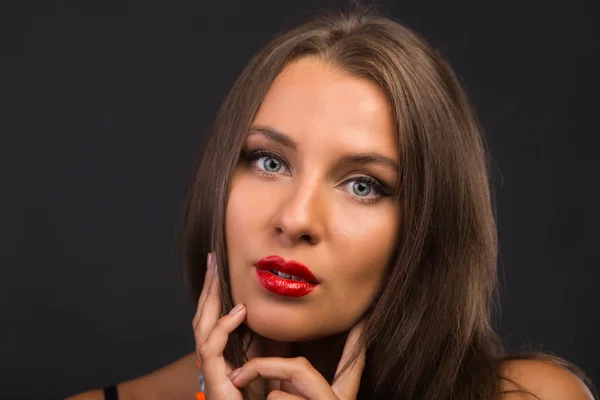 Beautiful brunette in a dark dress — Stock Photo, Image