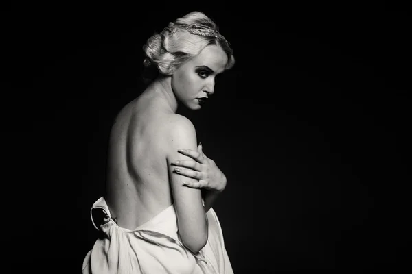 Beautiful blonde in vintage dress on a dark background — Stock Photo, Image