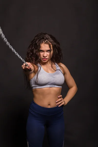 The beautiful sports girl on a dark background — Stock Photo, Image