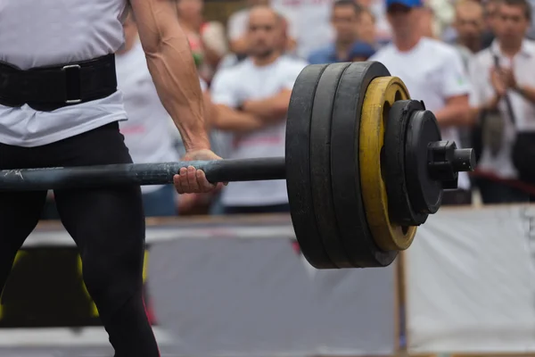 Professional athletes performing strength exercises.