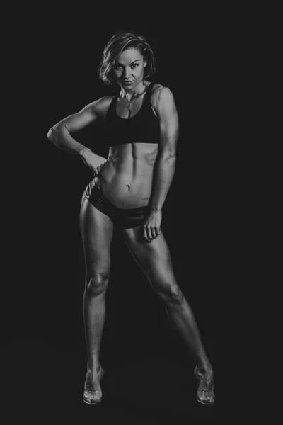 Das schöne Sportmädchen auf dunklem Hintergrund — Stockfoto