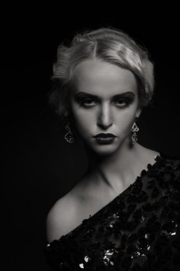 Karanlık bir arka plan üzerinde vintage elbiseli güzel sarışın