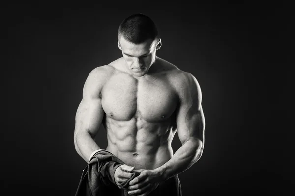 Uomo muscoloso in giacca sportiva su sfondo scuro — Foto Stock