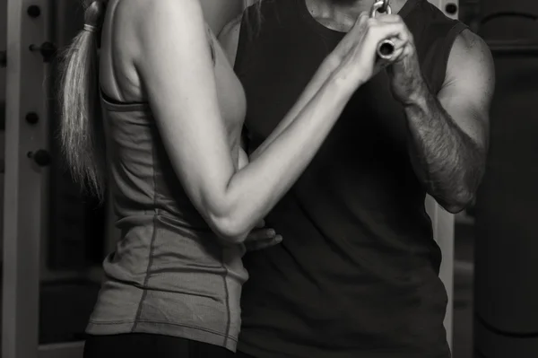 Young couple in the gym at the joint training — Stock Photo, Image